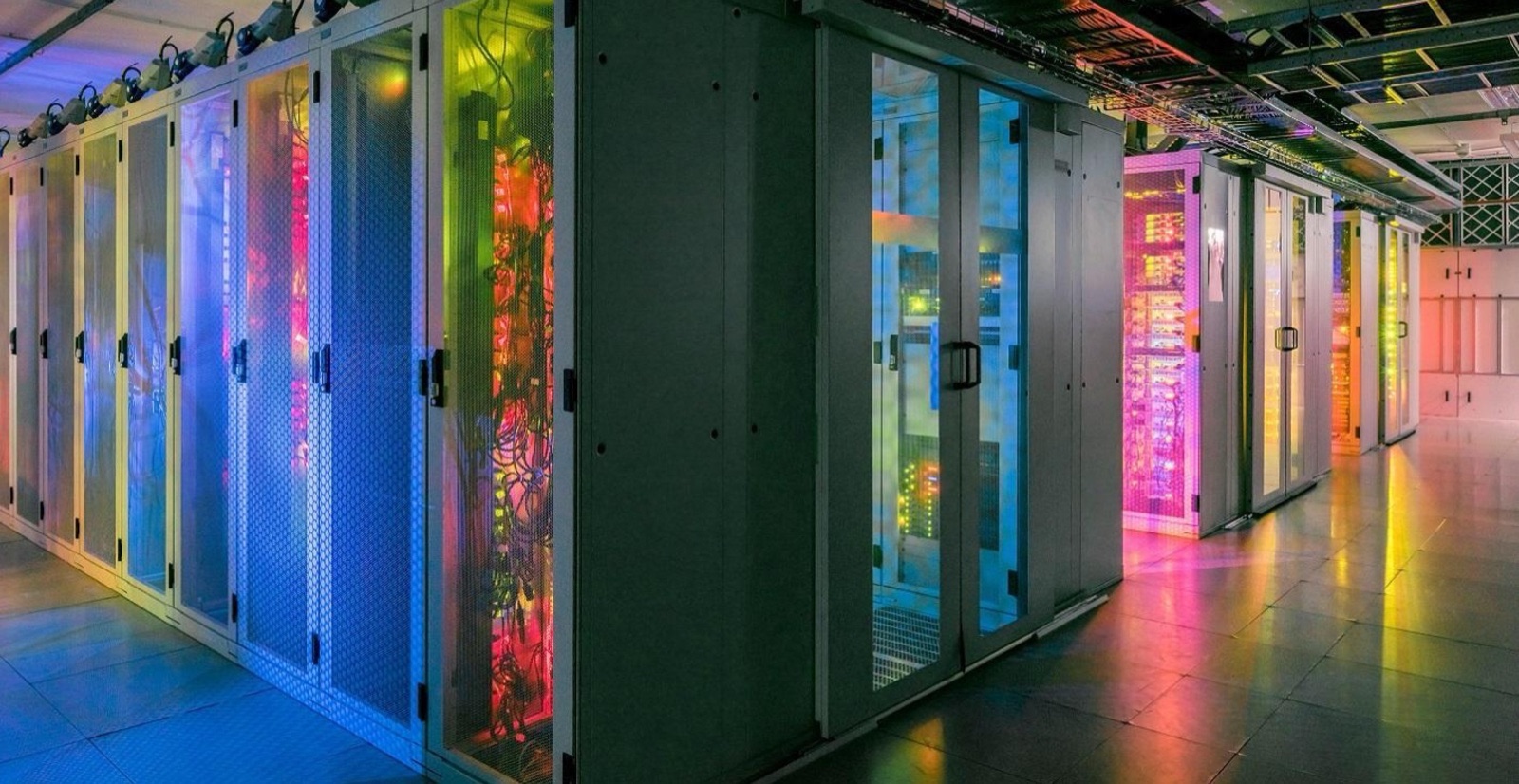 Rows of illuminated server racks in an Origon data center